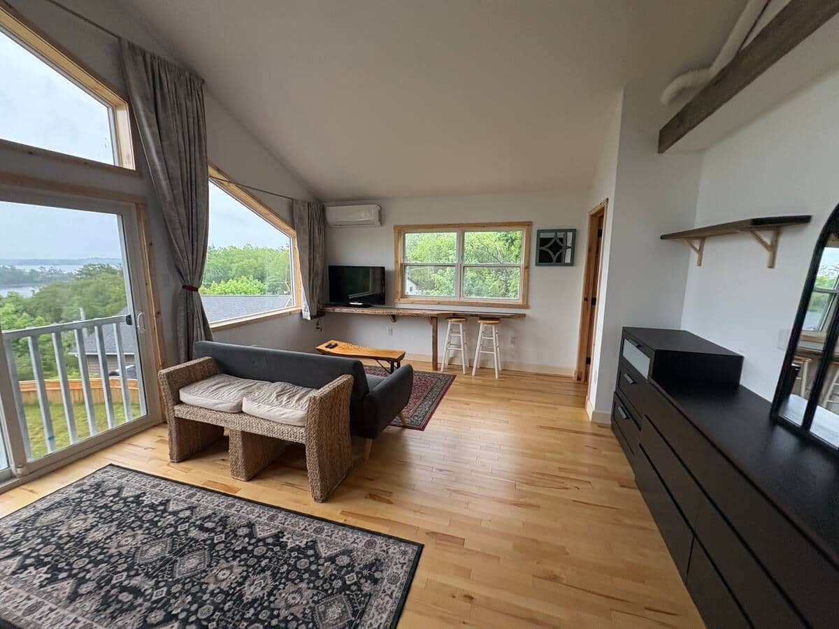 Primary bedroom sitting area with large windows